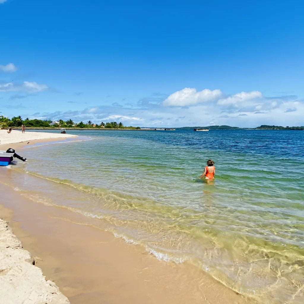 Mulher relaxando nas águas transparentes da Ilha do Campinho, Baía de Camamu; um cenário de paz no roteiro da Ilhéus Passeios.